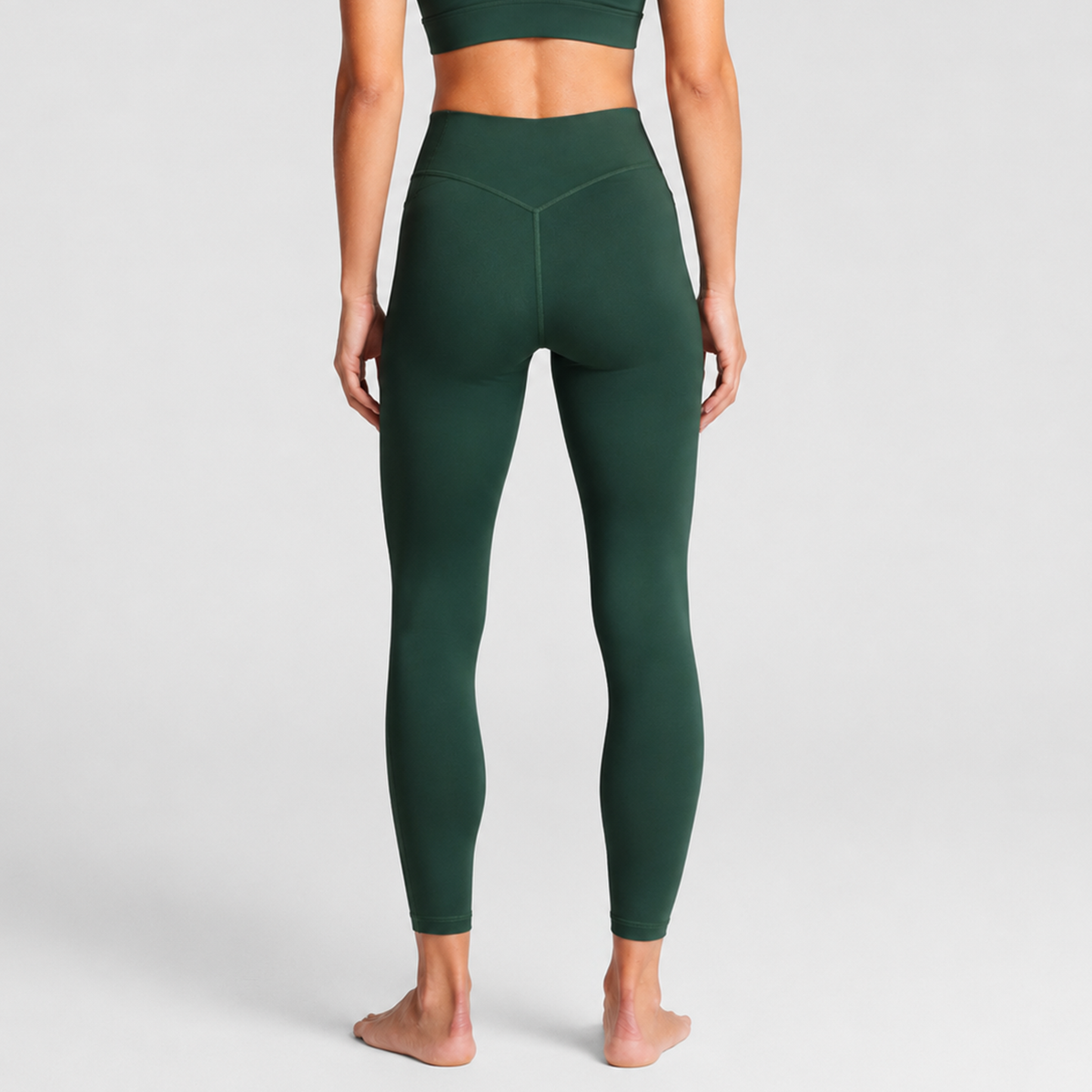 Woman wearing olive Trimline 7/8 Leggings by Definite Articles, viewed from behind.