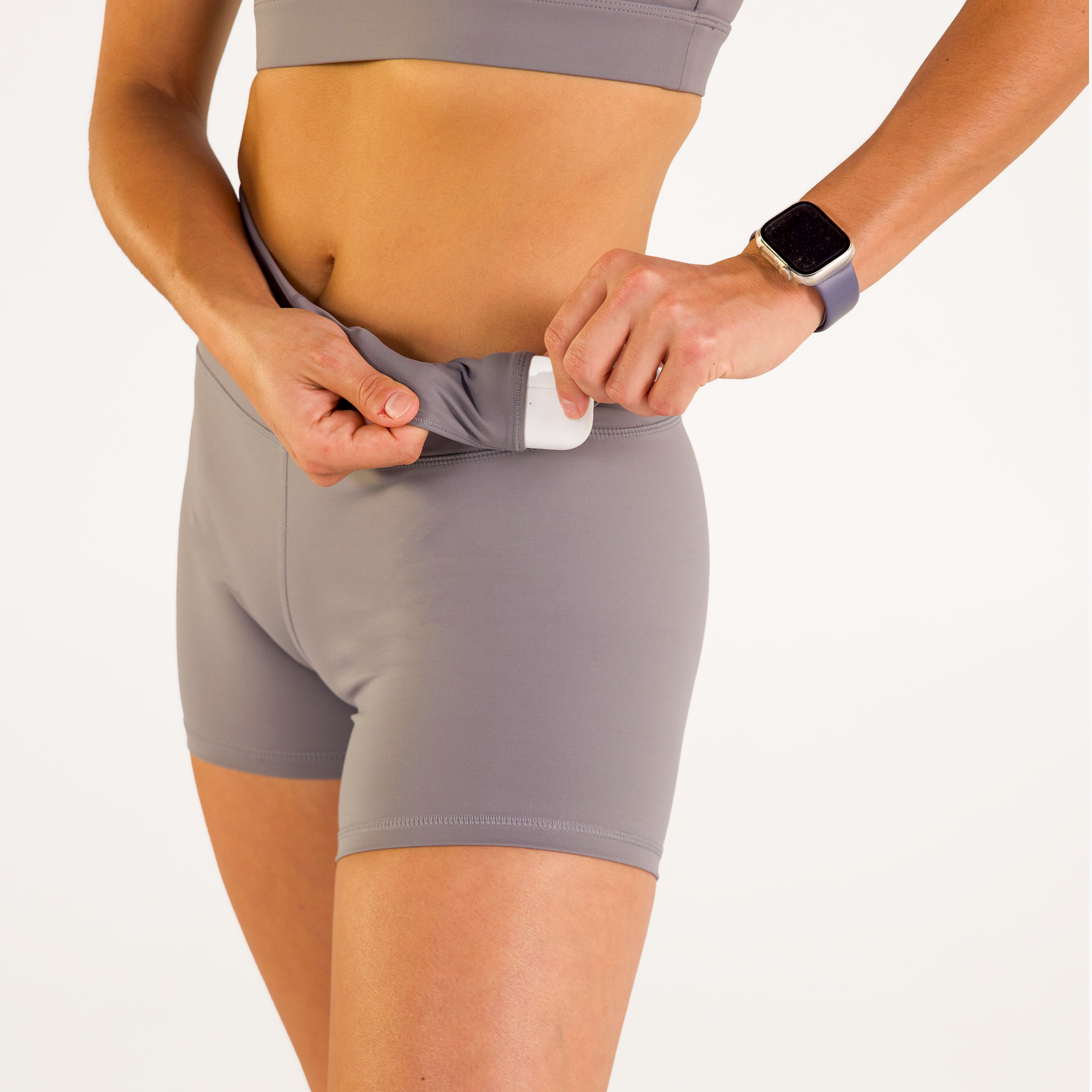 Woman wearing abalone shell Trimline 5" Shorts by Definite Articles. Closeup on pockets.