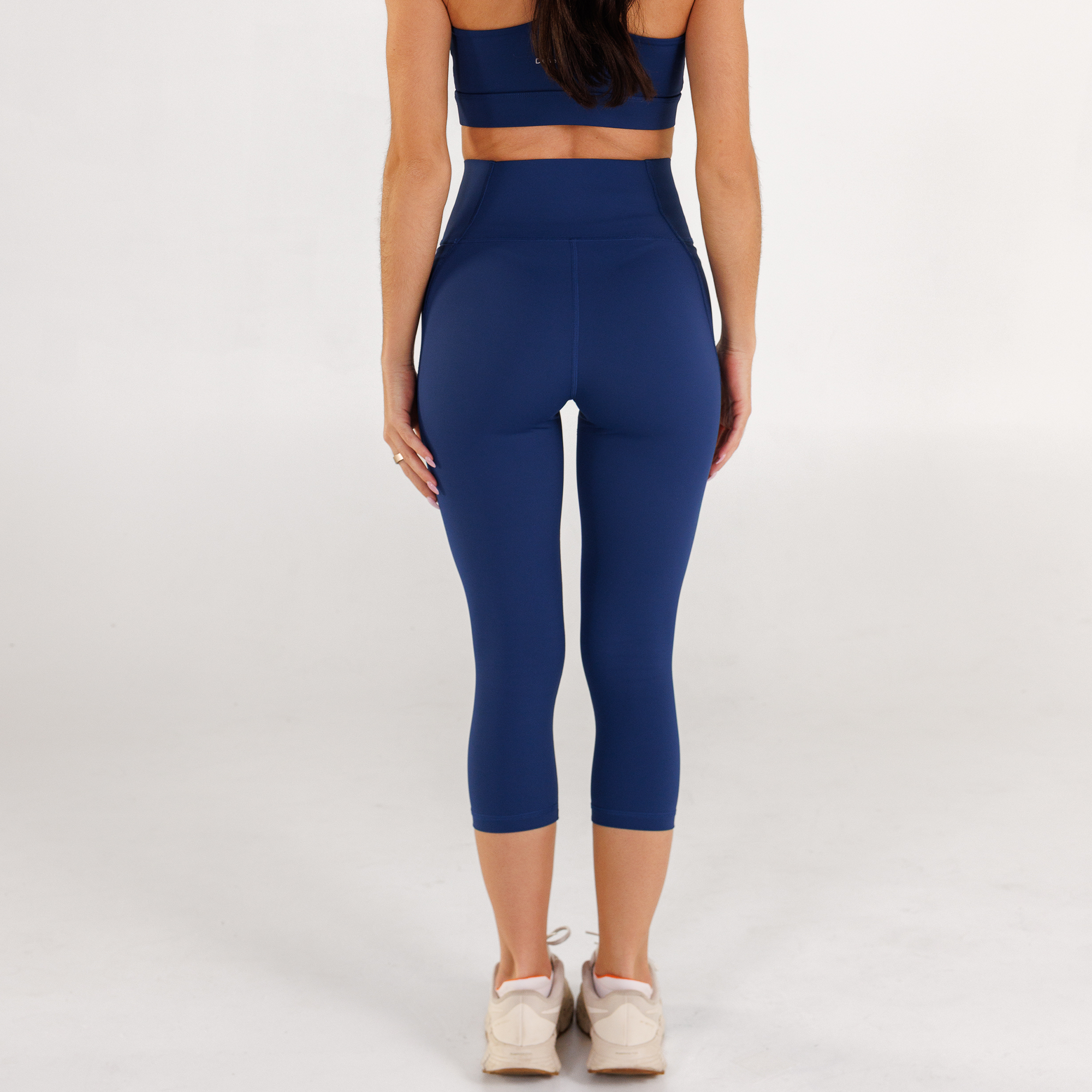 Woman wearing estate blue Trimline Capri Leggings by Definite Articles.