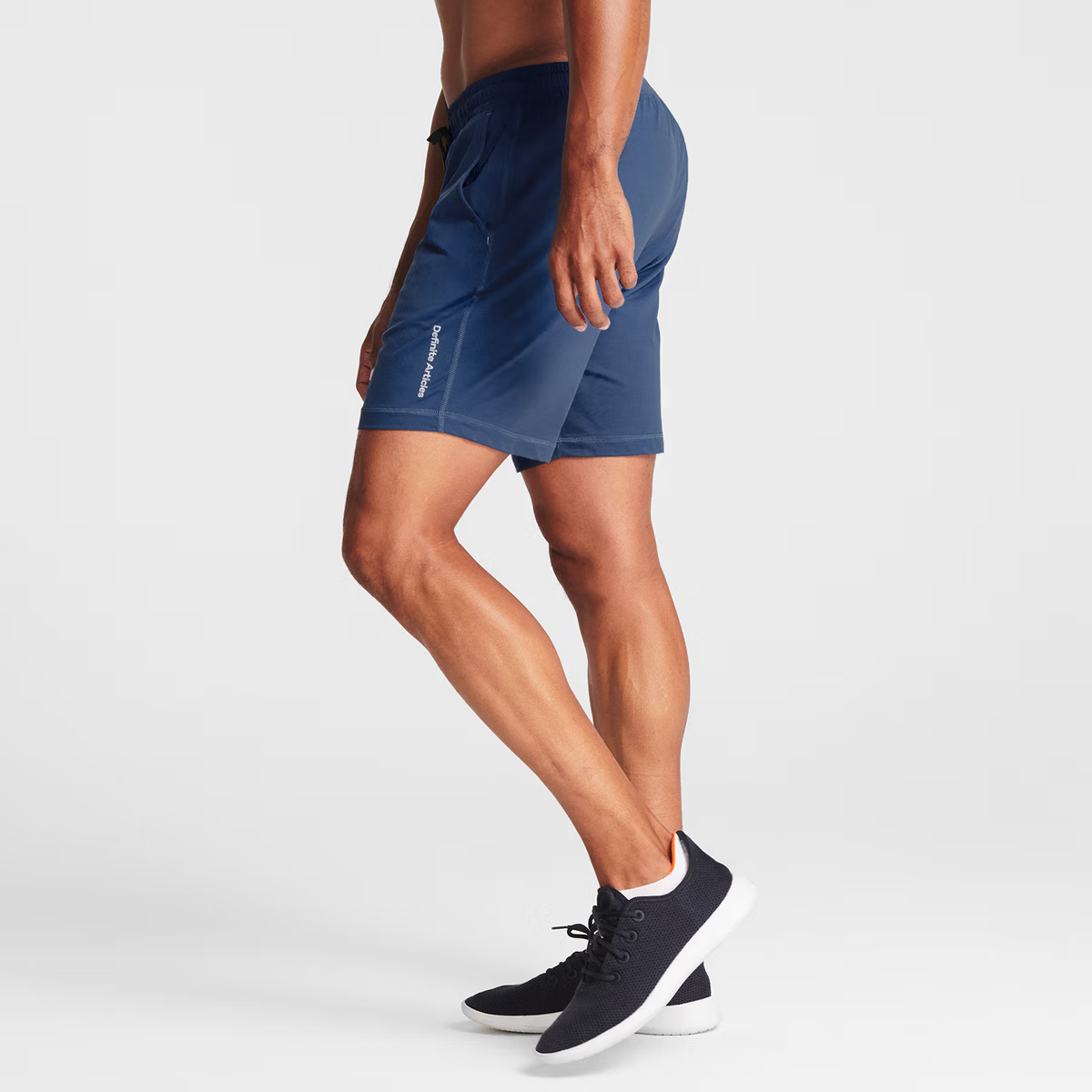 Man wearing navy blue Tor Shorts by Definite Articles.