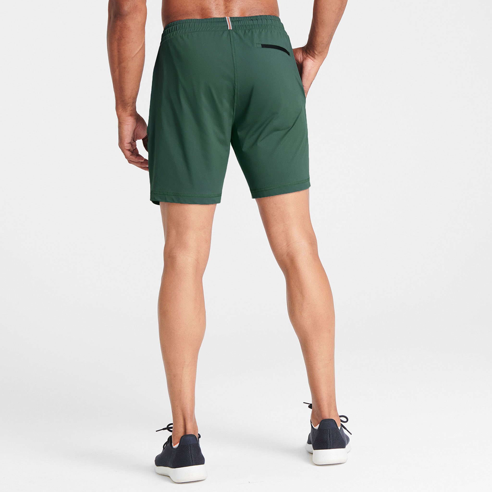 Man wearing olive Tor Shorts by Definite Articles. White background.