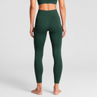 Woman wearing olive Trimline 7/8 Leggings by Definite Articles, viewed from behind.