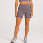 Woman wearing abalone shell Trimline 5" Shorts by Definite Articles.