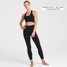 Woman wearing black Trimline Natural-Waist 7/8 Leggings by Definite Articles. Model is 5'8, 24" waist wearing size XS.