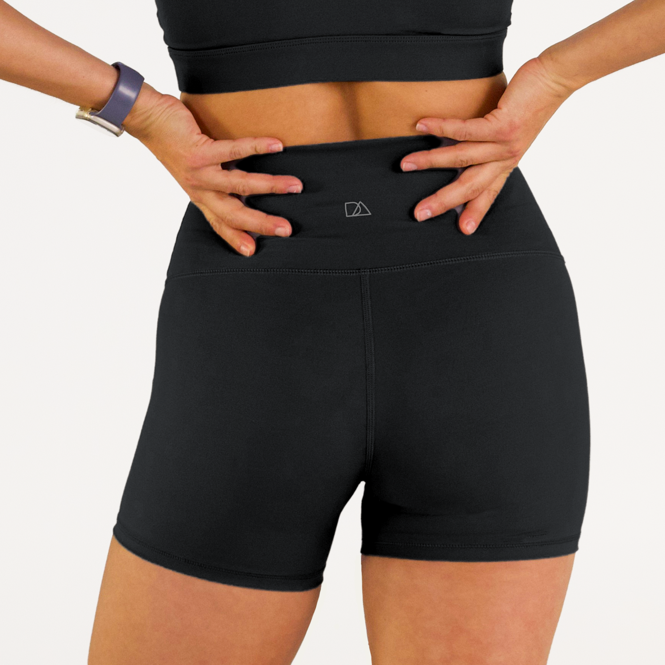 Woman wearing black Trimline 5" Shorts by Definite Articles.
