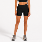 Woman wearing black Trimline 5" Shorts by Definite Articles.