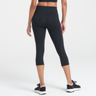 Woman wearing black Trimline Capri Leggings by Definite Articles.