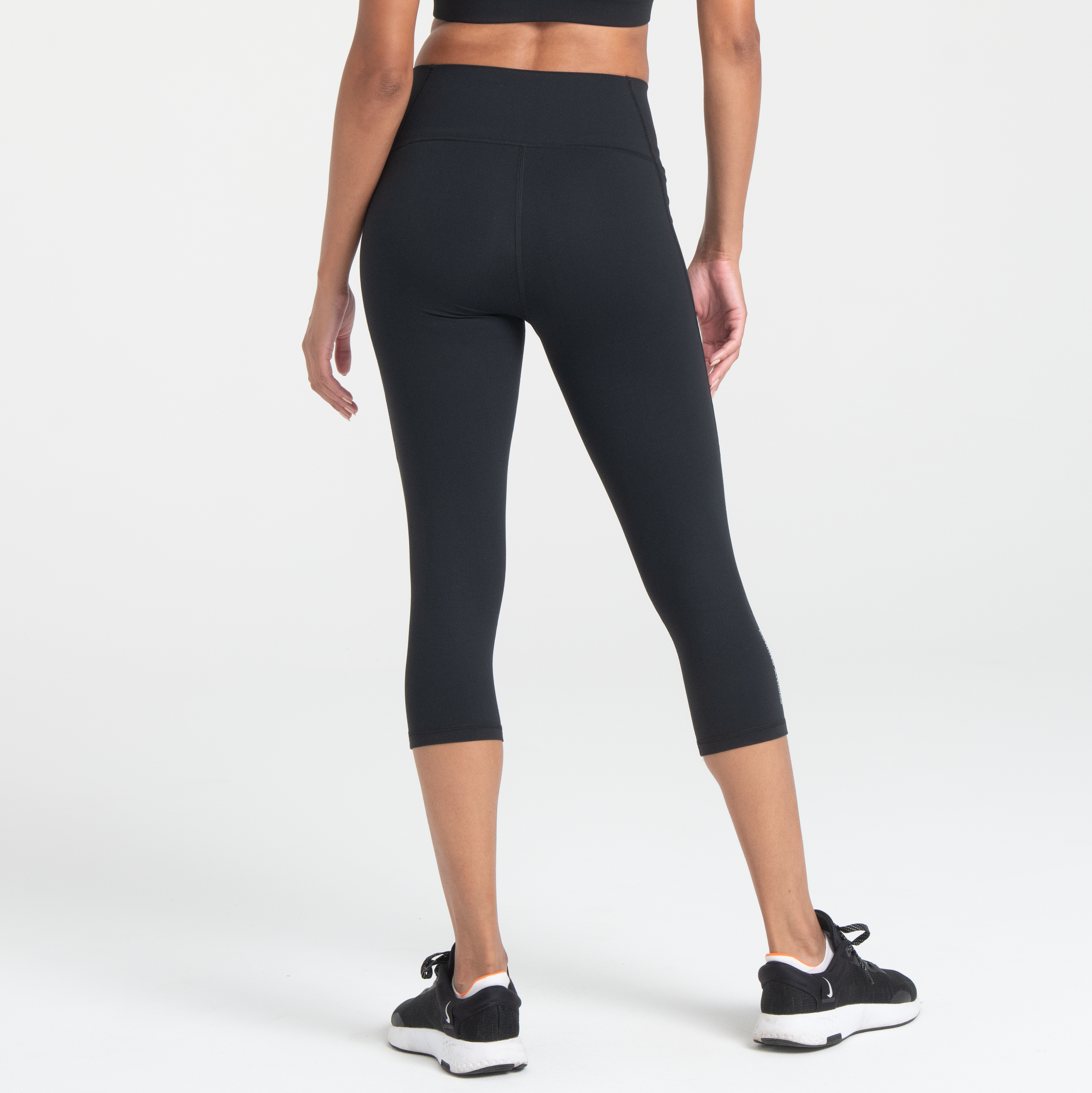Woman wearing black Trimline Capri Leggings by Definite Articles.