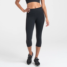Woman wearing black Trimline Capri Leggings by Definite Articles.