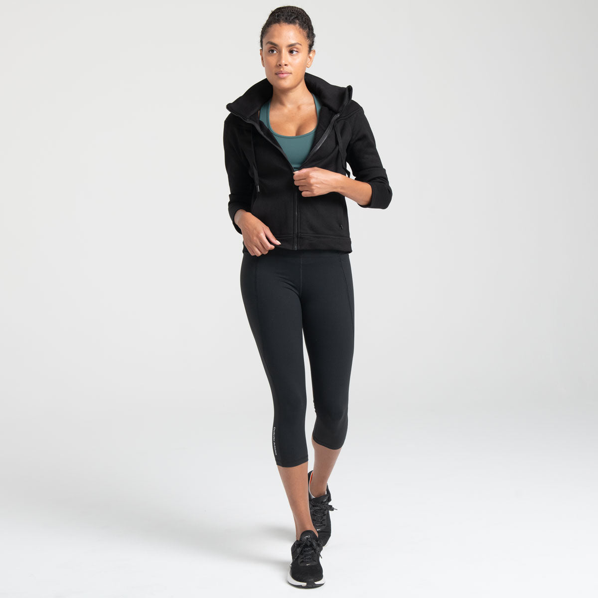 Woman wearing black Trimline Capri Leggings by Definite Articles.
