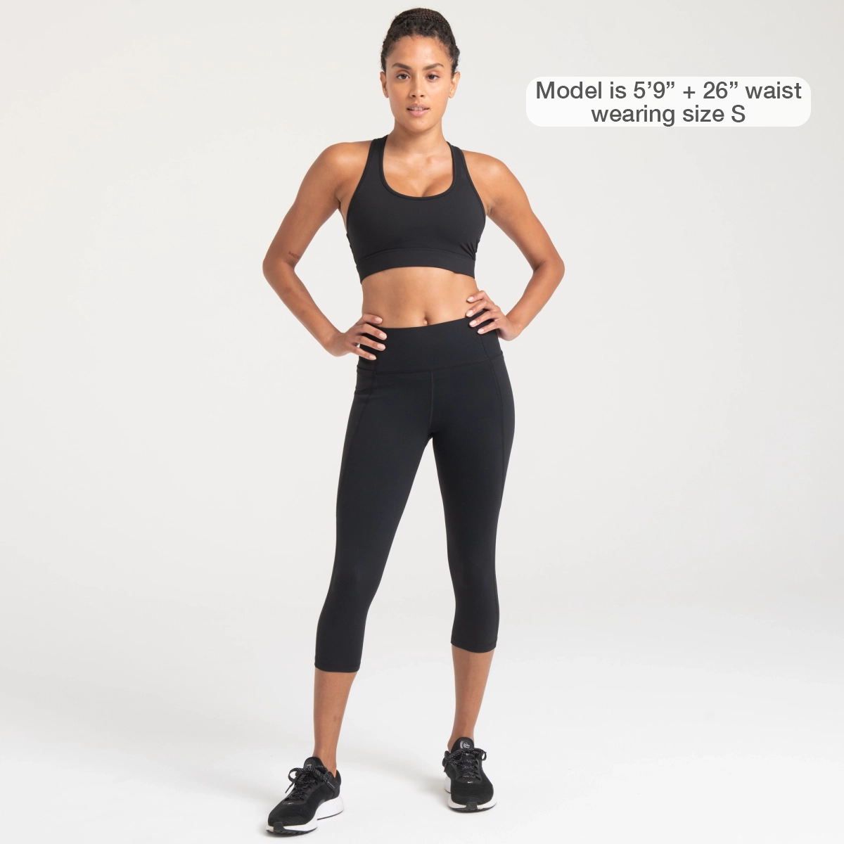 Woman wearing black Trimline Capri Leggings by Definite Articles. Model is 5"9" + 26" waist wearing a size small.