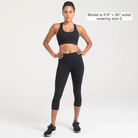 Woman wearing black Trimline Capri Leggings by Definite Articles. Model is 5"9" + 26" waist wearing a size small.