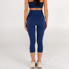 Woman wearing estate blue Trimline Capri Leggings by Definite Articles.