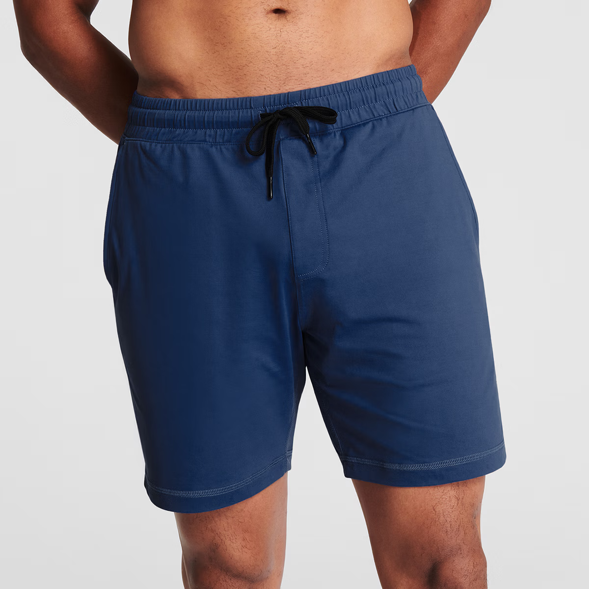 Man wearing navy blue Tor Shorts by Definite Articles. 