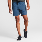Man wearing ocean blue Tor Shorts  by Definite Articles. 