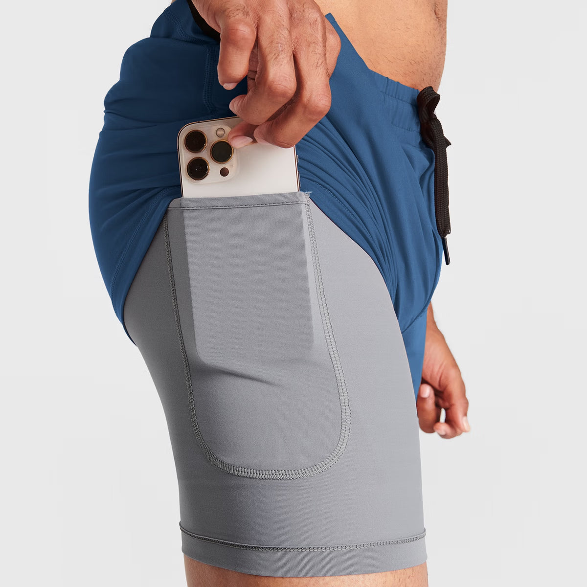 Man wearing ocean blue Tor Shorts  by Definite Articles. Closeup on pockets.