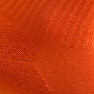 Orange women's crew sock by Definite Articles, close-up of fabric texture