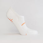 White women's gripper sock by Definite Articles, on foot showing grip sole