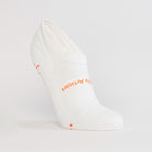 White women's gripper sock by Definite Articles, close-up of grip dots on sole