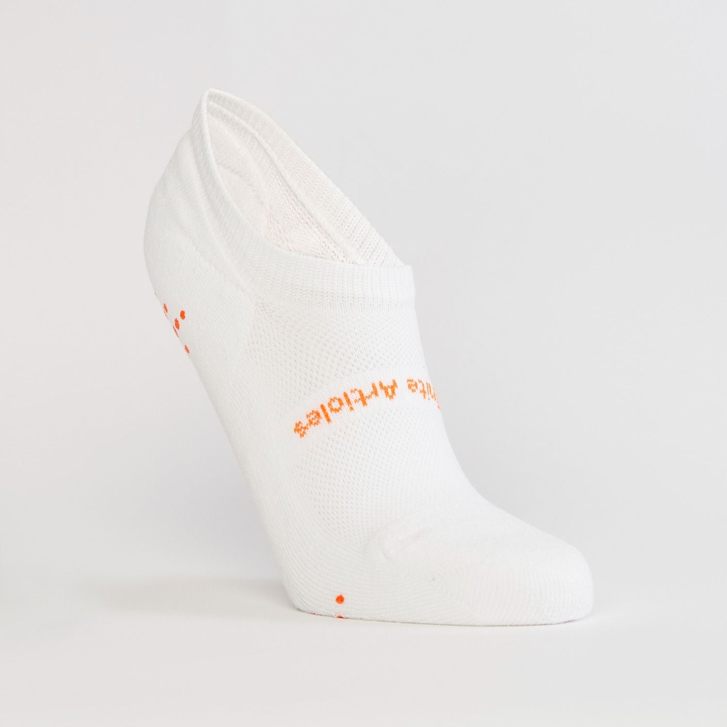 White women's gripper sock by Definite Articles, close-up of grip dots on sole