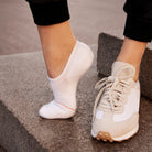 Woman wearing white no-show sock by Definite Articles, on foot